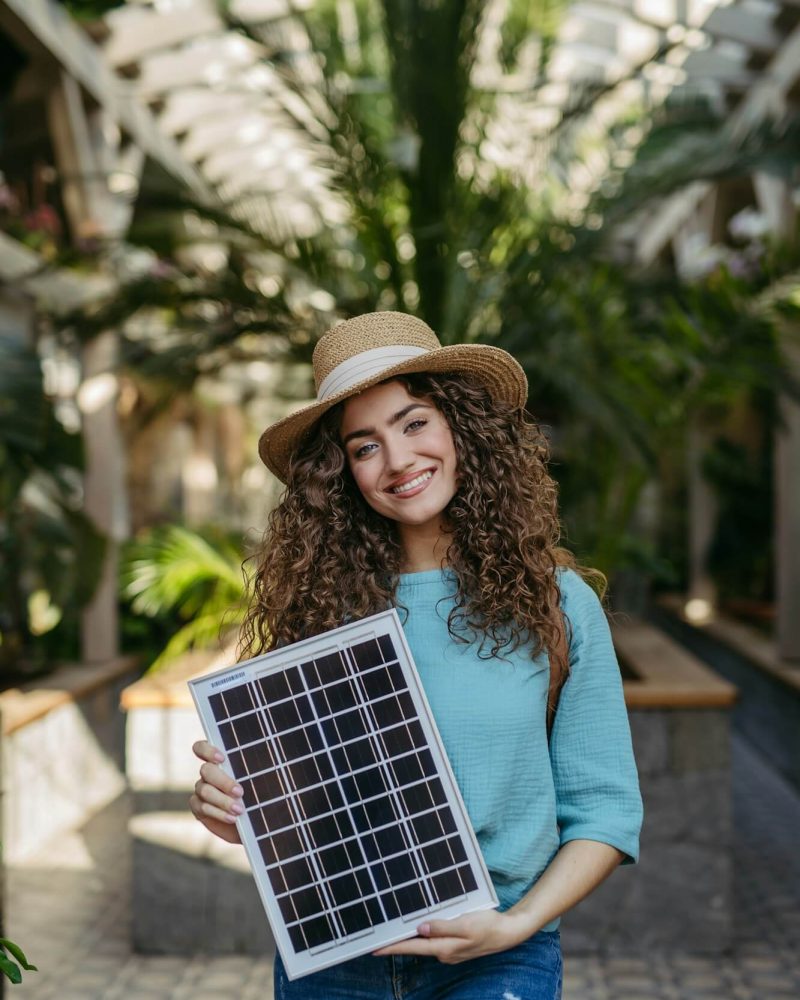 young-woman-in-botanical-garden-holding-solar-panel-concept-of-green-energy-.jpg